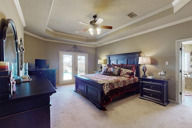 bedroom featuring visible vents, a raised ceiling, light colored carpet, access to exterior, and french doors