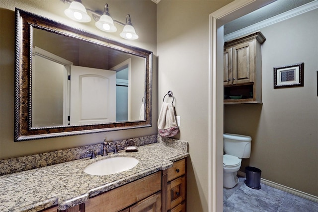 bathroom with ornamental molding, baseboards, vanity, and toilet