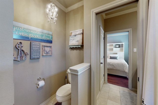 bathroom with toilet, a notable chandelier, baseboards, ornamental molding, and tile patterned floors