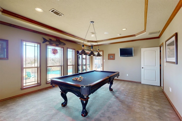 recreation room featuring carpet floors, a tray ceiling, visible vents, and crown molding