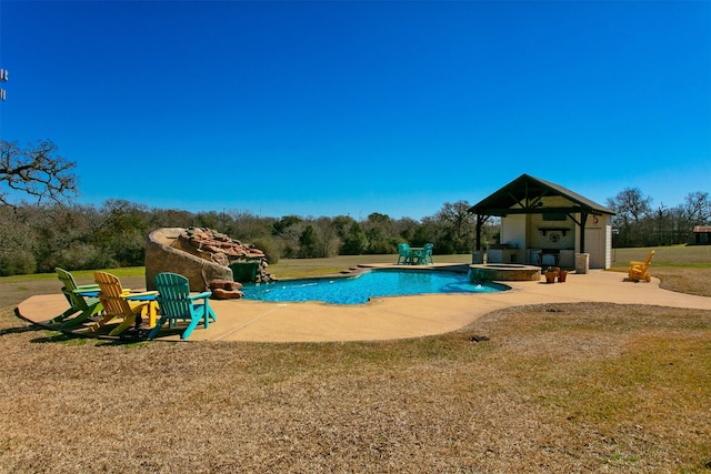 view of swimming pool with a pool with connected hot tub, a patio area, and a lawn