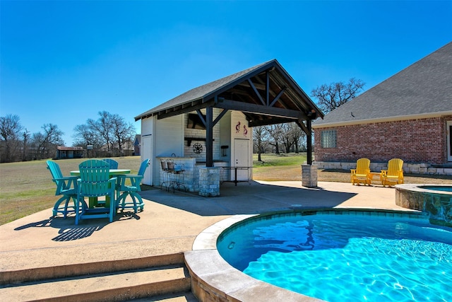 pool featuring a patio, an in ground hot tub, outdoor dry bar, a gazebo, and a lawn