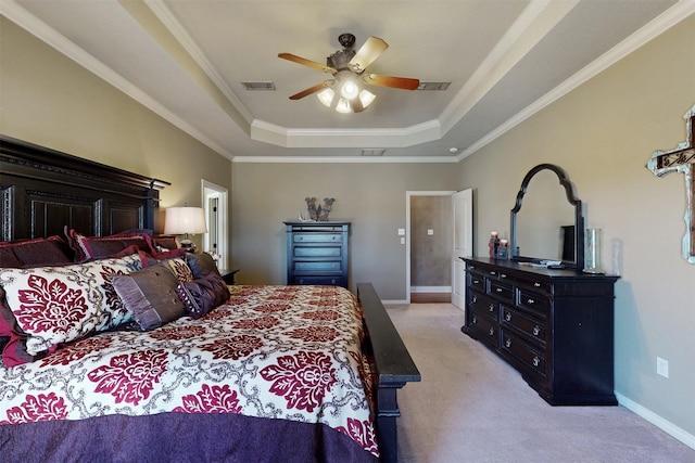 bedroom with ornamental molding, baseboards, a raised ceiling, and light colored carpet