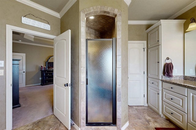 bathroom with a stall shower, crown molding, and vanity