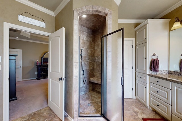 full bathroom with ornamental molding, a shower stall, vanity, and baseboards