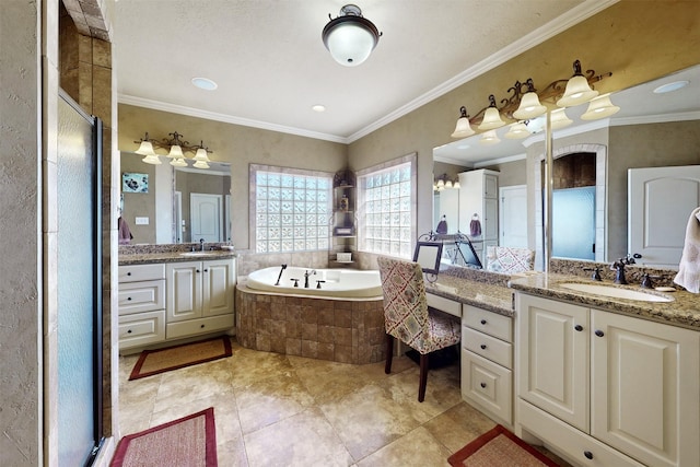 full bathroom with a bath, a shower stall, two vanities, and a sink