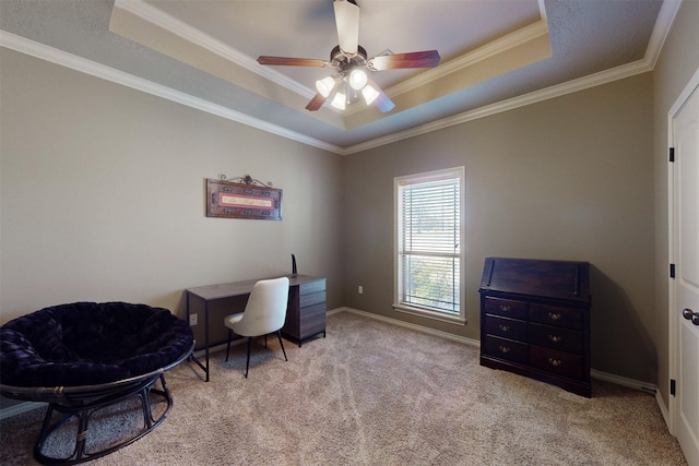 home office with ornamental molding, a tray ceiling, light colored carpet, and baseboards