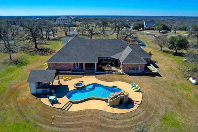 view of pool featuring a lawn and a patio