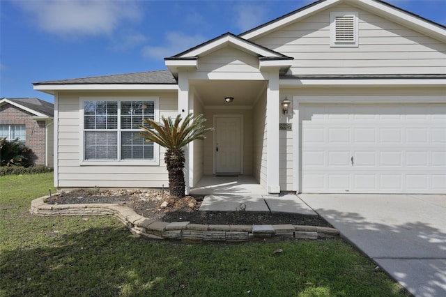 single story home featuring a garage, concrete driveway, and a front lawn