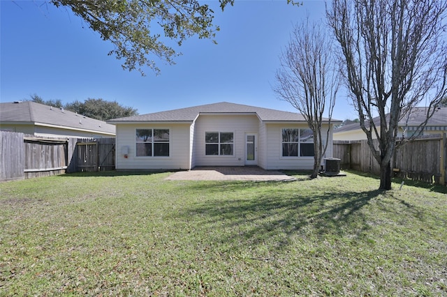 rear view of house with cooling unit, a fenced backyard, and a lawn