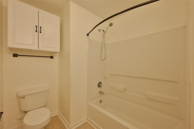 bathroom featuring toilet, washtub / shower combination, baseboards, and tile patterned floors