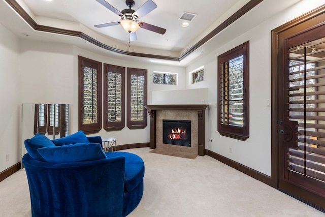 sitting room featuring carpet floors, a tray ceiling, a wealth of natural light, and baseboards