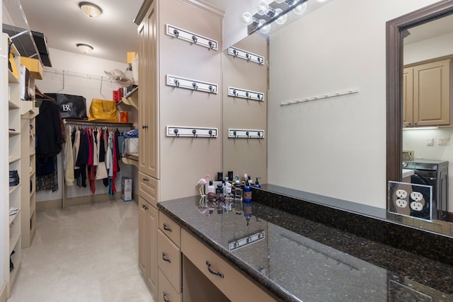 interior space featuring dark stone counters and cream cabinets