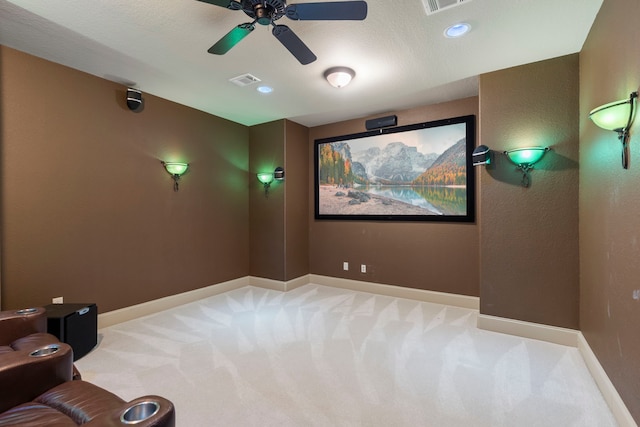 carpeted home theater with ceiling fan, recessed lighting, visible vents, and baseboards