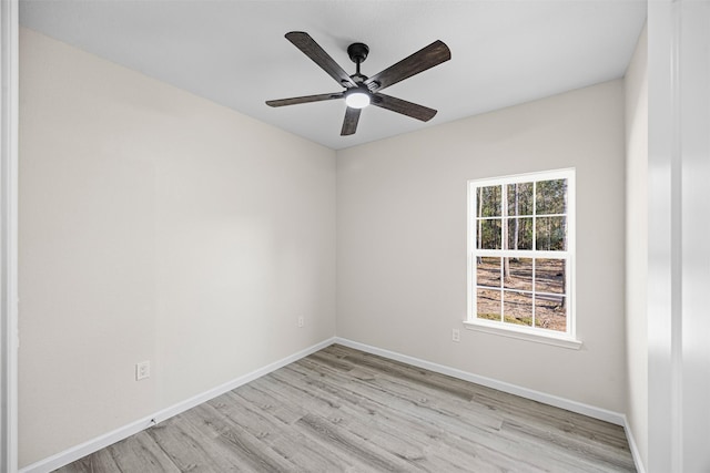 empty room with baseboards, ceiling fan, and light wood finished floors