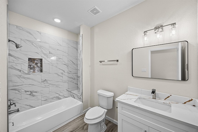 full bath featuring shower / bath combination, visible vents, toilet, wood finished floors, and vanity