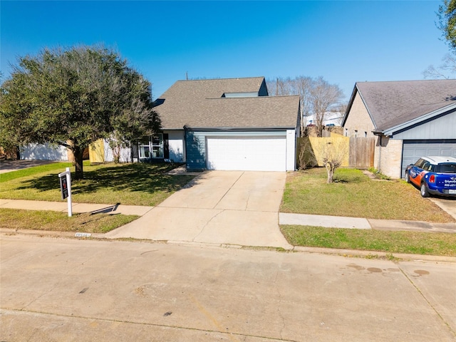 view of front facade featuring a garage, fence, a front lawn, and concrete driveway