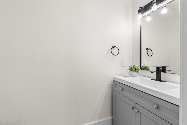 bathroom with vanity and baseboards