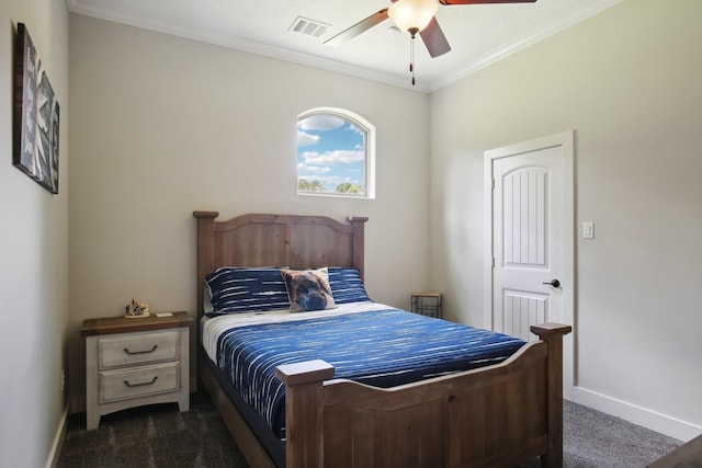 bedroom with baseboards, visible vents, dark colored carpet, and crown molding