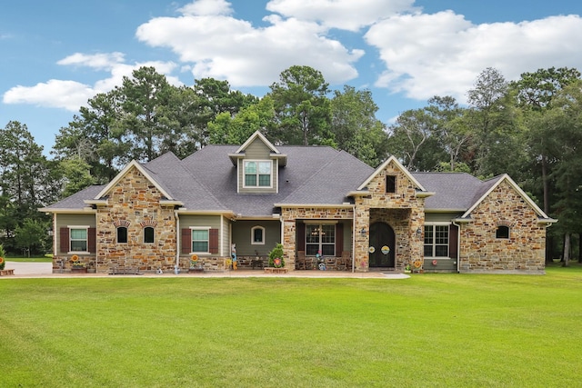 craftsman inspired home with a shingled roof, stone siding, and a front lawn