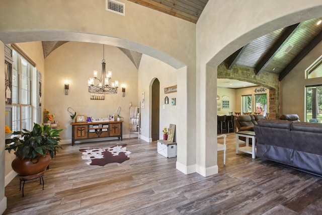 foyer featuring visible vents, wood ceiling, wood finished floors, beamed ceiling, and baseboards