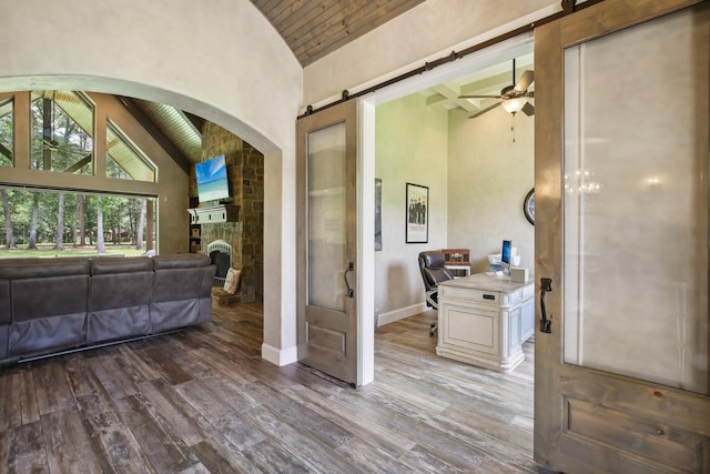 interior space featuring wood ceiling, high vaulted ceiling, and wood finished floors