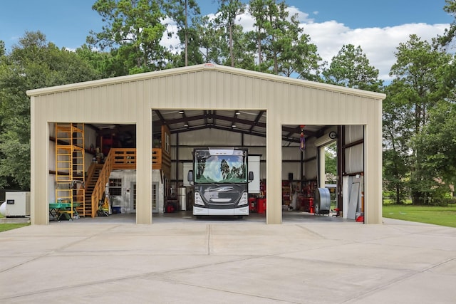 exterior space featuring a garage, an outbuilding, and stairway