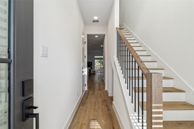 interior space featuring baseboards, visible vents, wood finished floors, and recessed lighting