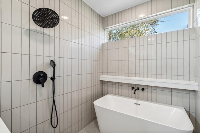 full bathroom with a soaking tub, a tile shower, and tile walls