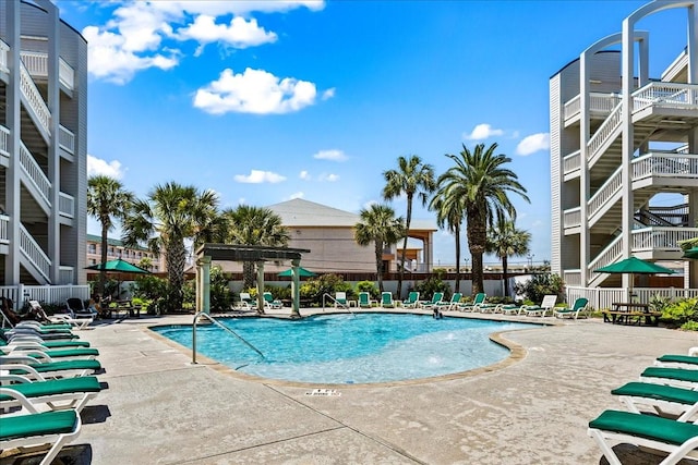 pool featuring a pergola, a patio, and fence