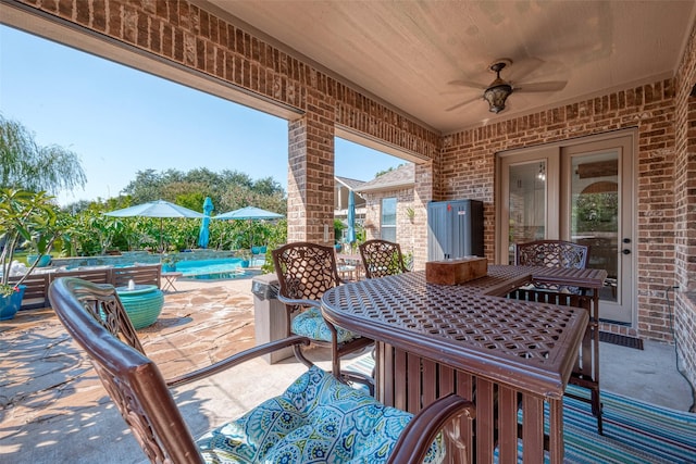 view of patio / terrace featuring ceiling fan, outdoor dining area, and an outdoor pool