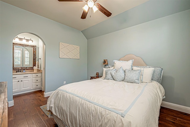 bedroom with vaulted ceiling, baseboards, and dark wood finished floors