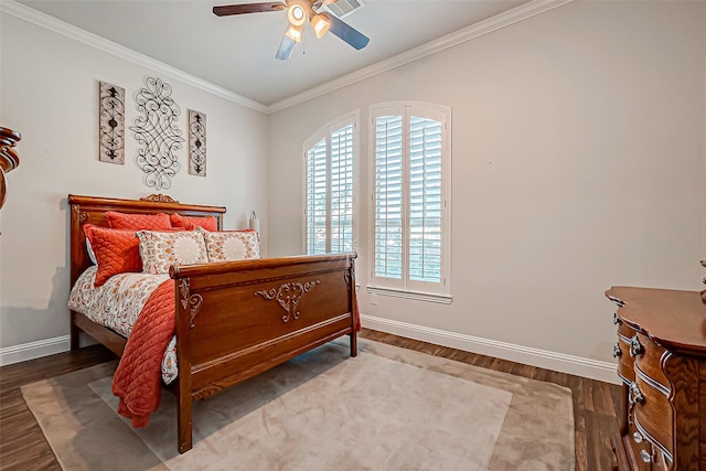 bedroom with baseboards, wood finished floors, and ornamental molding