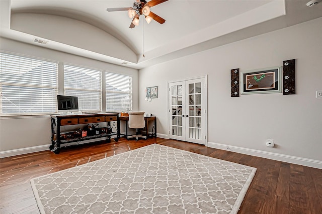 home office with hardwood / wood-style flooring, visible vents, baseboards, vaulted ceiling, and french doors