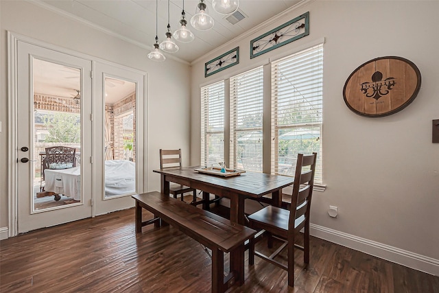 dining room with ornamental molding, dark wood-style flooring, visible vents, and plenty of natural light