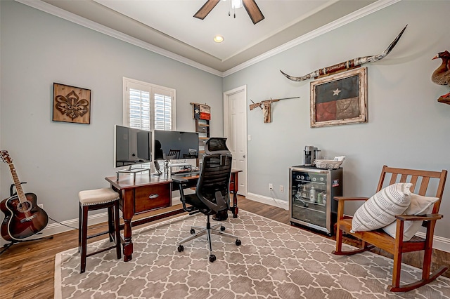 office featuring beverage cooler, baseboards, ceiling fan, ornamental molding, and wood finished floors