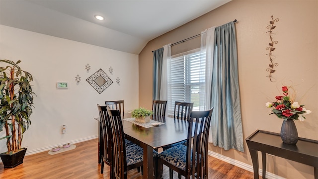 dining space featuring lofted ceiling, recessed lighting, wood finished floors, and baseboards