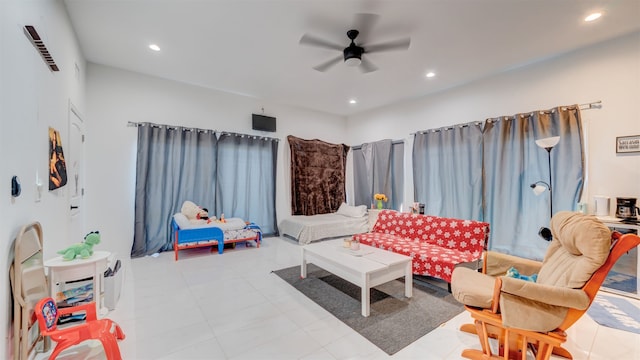 living room with a ceiling fan, recessed lighting, and visible vents