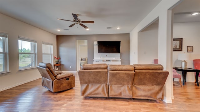 living area featuring light wood-style flooring, visible vents, and recessed lighting