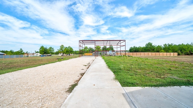 view of home's community featuring fence and a yard