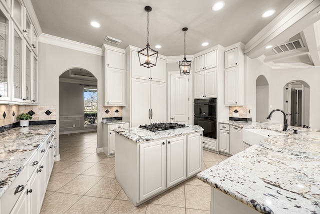 kitchen with ornamental molding, visible vents, stainless steel gas cooktop, and a sink