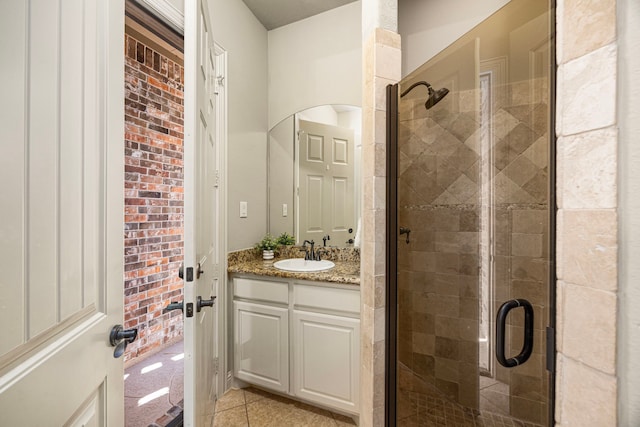 bathroom featuring a shower stall, vanity, and tile patterned floors