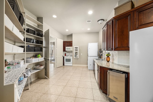 kitchen with open shelves, recessed lighting, decorative backsplash, light stone countertops, and white appliances