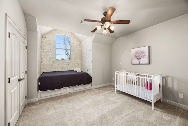 carpeted bedroom with lofted ceiling, visible vents, ceiling fan, and baseboards