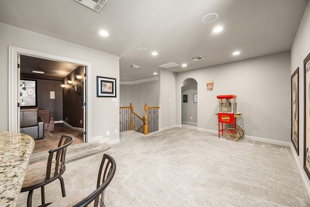 interior space featuring arched walkways, recessed lighting, visible vents, carpet flooring, and an upstairs landing