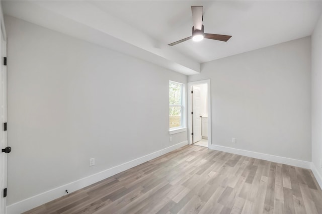 unfurnished bedroom with a ceiling fan, connected bathroom, light wood finished floors, and baseboards