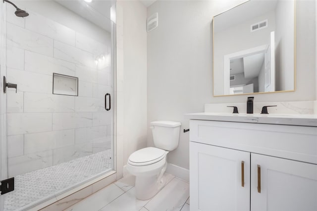 bathroom with toilet, vanity, baseboards, visible vents, and a shower stall