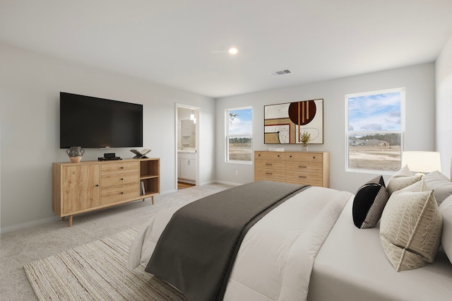 bedroom with light carpet, baseboards, visible vents, and ensuite bathroom