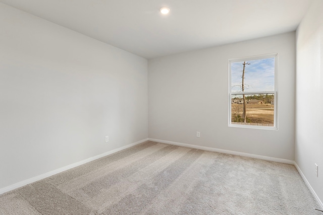 carpeted empty room with baseboards and recessed lighting