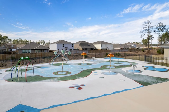 view of property's community featuring a residential view, playground community, and fence